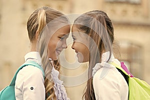 Soulmate friends. Small schoolgirls wear school uniform. Cute schoolgirls with long ponytails looking charming. Ending