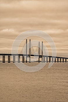 The Sound Bridge, connecting Malmo, Sweden with Copenhagen, Denmark. A beautiful orange sunset sky in the background