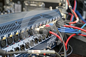 Sound cables connected in a mixing console at the soundcheck for an open air festival concert, selected focus