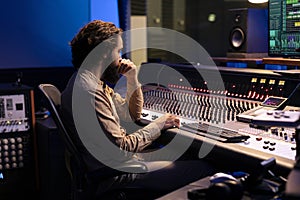 Sound designer mixing and mastering music in recording studio