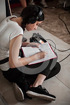 Sound director technician with headset writing sound recorder audio script
