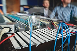 Sound editor engineer working at studio with mixing panel, mixing music and sound, stage sound mixer, boutique recording studio,