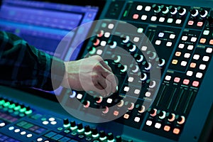 Sound engineer controls digital mixing console