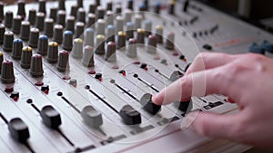 Sound Engineer, DJ Moves Sliders with Fingers on Audio Mixer in Recording Studio