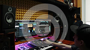 Sound engineer recording song for female young singer at professional music studio. Musician recording female voice at home record