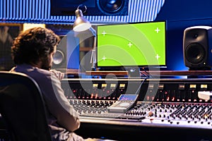 Sound engineer working with isolated display in studio control room