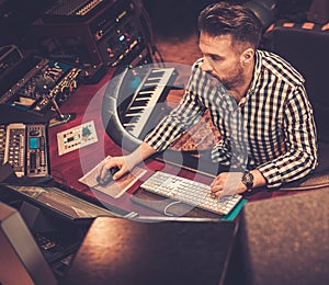 Sound engineer working at mixing panel