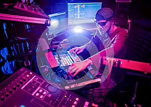 Sound engineer working at mixing panel in the in sound recording studio.