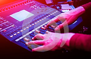 Sound engineer working at mixing panel in the in sound recording studio.