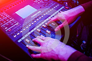 Sound engineer working at mixing panel in the in sound recording studio.