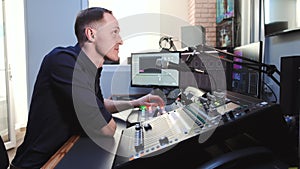 Sound engineer working in studio with equipment