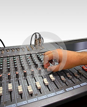 Sound mixer console and hand on white