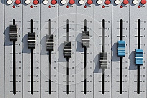 Sound mixing desk faders. Music studio recording equipment volume close-up