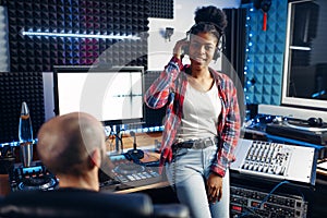 Sound producer and female performer in studio