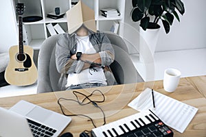 Sound producer sleeping with magazine on face photo