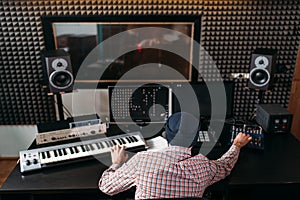 Sound producer work with audio equipment in studio