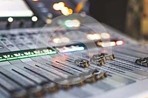 Sound recording studio mixer desk: sound engineer is operating a professional music production
