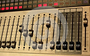 Sound studio adjusting record equipment.