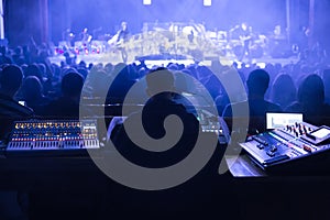 Soundman working on the mixing console.