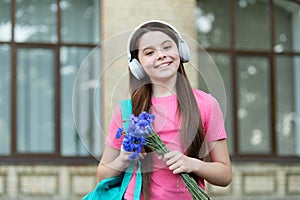 It sounds cool. Cool girl listen to music outdoors. Happy child use headphones for listening. Cool music beat. New
