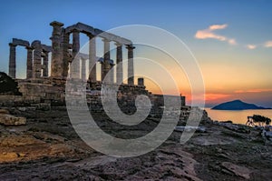 Sounion, Attica / Greece: Colorful sunset at Cape Sounion and the ruins of the temple of Poseidon