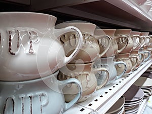 Soup bowls in a pile on a shelf in the store