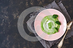 Soup cream of broccoli served in a bowl on dark background,top view. Place for the test.