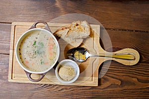 Soup with croutons on the wooden table