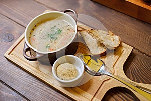 Soup with croutons on the wooden table