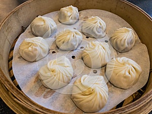 Soup dumplings steamed in bamboo steaming baskets photo