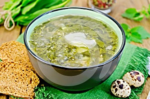 Soup green of sorrel and nettles with eggs on the board