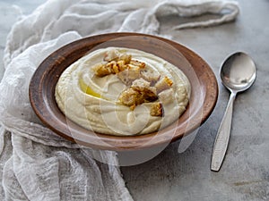 Soup of Jerusalem artichoke and croutons. Vegan cream soup in ceramic bowl. Close up. Copy space.