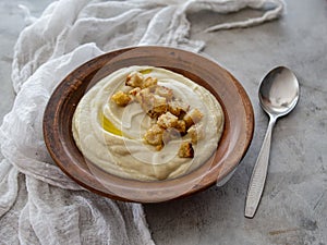 Soup of Jerusalem artichoke and croutons. Vegan cream soup in ceramic bowl. Close up. Copy space.