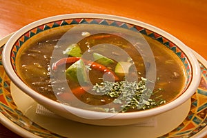 Soup with meat and avocado photo