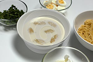 Soup in a plate close-up on a light background