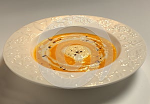 Soup in a plate close-up on a light background