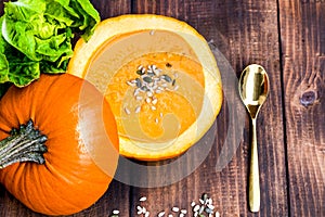 Soup in a pumpkin with different pumpkins for autumn dinner