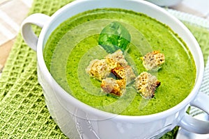 Soup puree with croutons and spinach on napkin