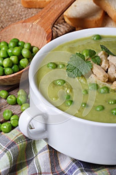 Soup puree of fresh green peas macro. Vertical