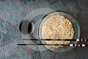 Soup Ramen noodles in glass bowl on tte blue background