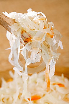 Sour cabbage - sauerkraut - on wooden spoon