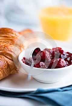 Sour cherry jam and croissant