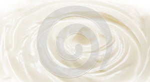 Sour cream or greek yogurt swirl texture, White cream background, close up. Dairy product