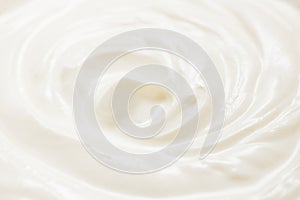 Sour cream or greek yogurt swirl texture, White cream background, close up. Dairy product