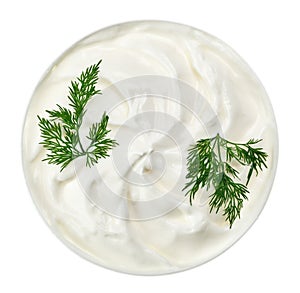 Sour cream in small round plate with dill twig