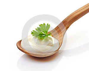 Sour cream in a wooden spoon