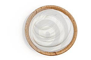 sour cream or yogurt in wooden bowl isolated on white background with full depth of field. Top view. Flat lay