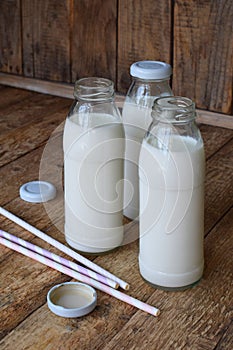 Sour-dairy drink or yoghurt in bottle that come from the kefir grains and milk on wooden background. Photographed with natural lig