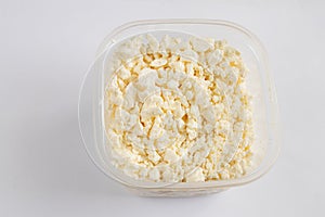 Sour milk curd in a white bowl on a white background