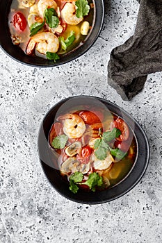 Sour and spicy tom yum soup with shrimps, mushrooms and tomatoes
